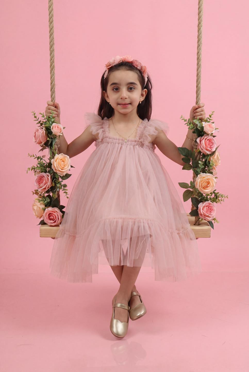 Child portrait on a floral swing