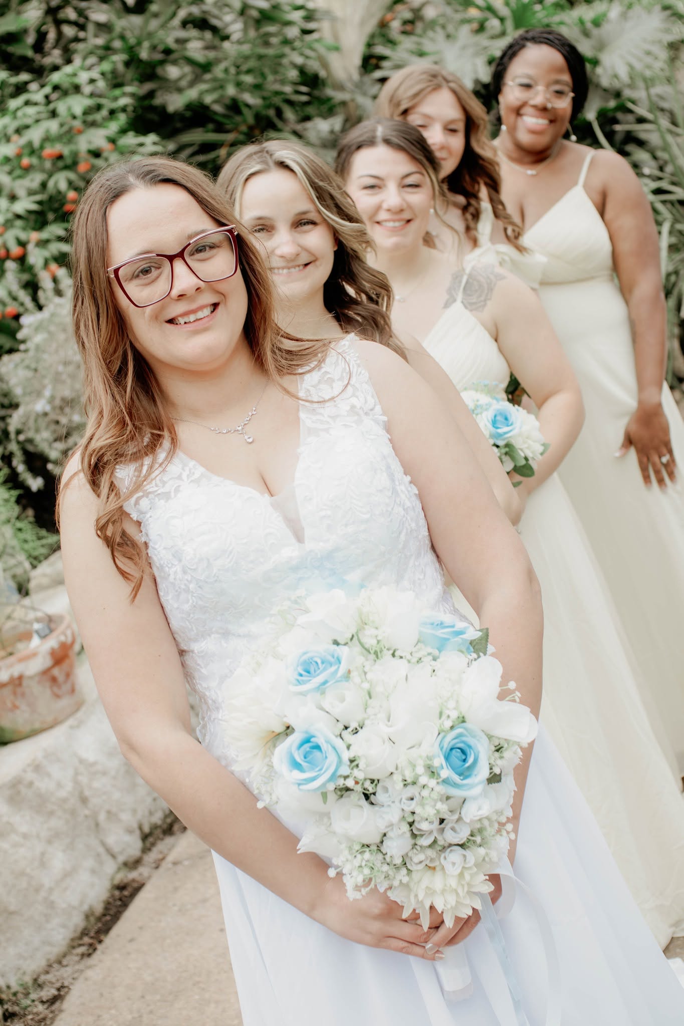 Bride with her wedding party in a garden